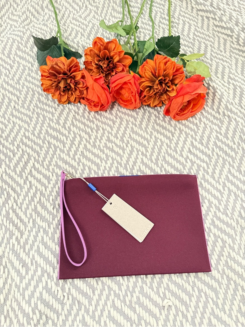 Rothy’s Women’s Wristlet Clutch in Plum with Pink Strap
